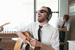 Young guitarist laughing in rehearsal room