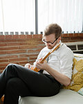 Young man practising on electric guitar