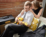 Young woman with partner practising on electric guitar