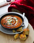 Bowl of maple carrot soup with scones