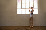 Ballet dancer using cell phone
