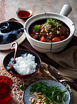 Table with Thai hot pot served with steamed rice