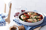 Still life with dish of chicken cacciatore and brown bread