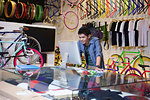 Young man in bike shop using computer
