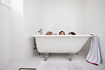 Three young girls peeking over bath