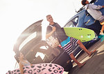 Family carrying surfboards, Encinitas, California, USA