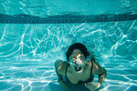 Young woman struggling underwater