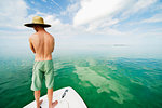 Young man standing on boat, Islamorada, Florida Keys, USA