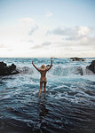 Young woman paddling in sea, Hana, Maui, Hawaii