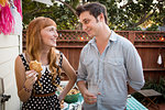 Young couple enjoying picnic lunch in garden