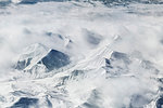 Aerial view of cloud and snow covered mountains, Western China, East Asia