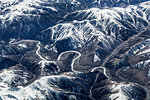 Aerial view of snow capped mountains and road, Western China, East Asia