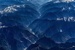 Aerial view of snow capped mountain range, Western China, East Asia