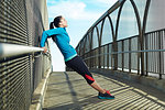 Mid adult woman stretching on bridge