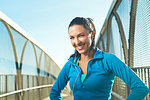 Mid adult woman wearing sports clothes standing on bridge