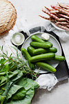 Cucumbers, beans and leaves, still life