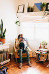 Father sitting on sofa with son