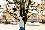 Father throwing son in air