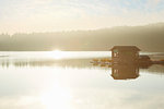 Boathouse on misty lake at sunrise, Orcas Island, Washington State, USA