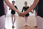 Rear view of a group of ballet school girls holding hands