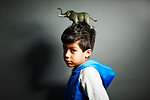 Boy with elephant ornament on top of head