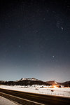 View of highway and snowy mountains at night, Pagosa Springs, Colorado, USA