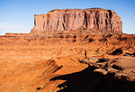 Distant view of woman looking out over  Monument Valley, Utah, USA