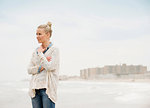 Mid adult woman looking out to sea, Rockaway Beach, New York, USA