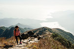 Young woman hiker on Lantau Peak looking away, Lantau Island, Hong Kong, China