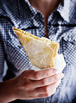 Mid section of mid adult man holding bougatsa custard pie