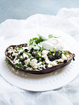 Still life of stuffed aubergines with ricotta and herbs