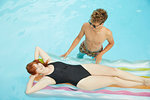 Overhead view of young couple in swimming pool