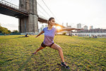 Young woman in yoga pose in park, New York, USA