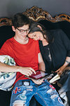 Woman sitting on antique sofa with son