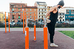 Man using parallel bars in outdoor gym