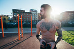 Man taking break in outdoor gym