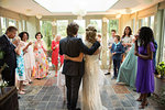 Wedding guests toasting to newlyweds at reception