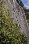 Rock climber scaling rock on Malamute, Squamish, Canada