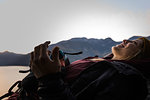 Rock climber lying down resting happy, Malamute, Squamish, Canada