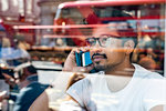 Man using smartphone in cafe