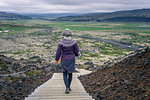 Woman walking around Grabrok volcano, Iceland