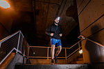 Runner with headlamp going down stairs, North Vancouver, Canada