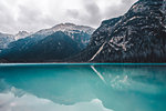 Landscape with turquoise lake and snow capped mountains, Dolomites, Italy