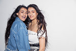 Portrait confident teenage twin sisters
