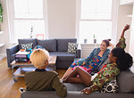 Young women friends hanging out in living room