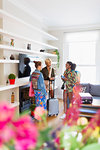 Young women friends with suitcases talking in house rental