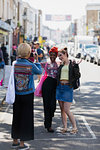 Young women friends posing for photograph on urban street