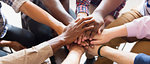 Men joining hands in group therapy