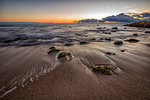 early morning at sea shore with stones on the beach