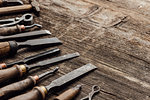 Old carving and woodworking tools on a vintage workbench: carpentry, woodworking and craftsmanship concept